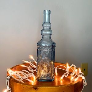 Sky Blue Tinted Clear Ornate Glass Bottle
Visit